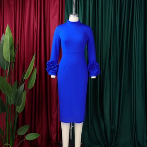 Detailed view of elegant royal blue dress featuring large 3D floral ruffles on sleeve cuffs