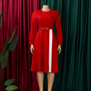 Close-up of elegant red dress featuring white side stripes and matched buckle waist belt
