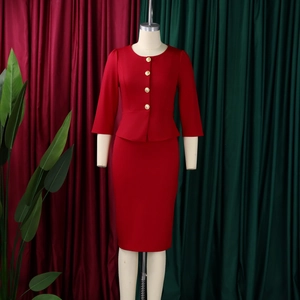 Detail of red peplum top and pencil skirt suit featuring elegant gold buttons