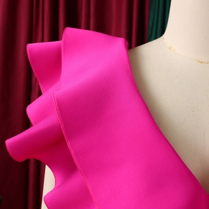 Detail of multi-layered rose red ruffles and hem stitching on a formal evening gown