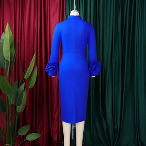 Close-up of royal blue slim-fit dress featuring 3D floral cuff details and mock neck style