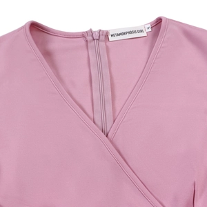 Close-up of pink V-neck knit dress with back zipper and internal brand size label