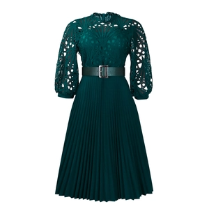 Detailed view of the dark green lace bodice and pleated skirt with thin leather belt