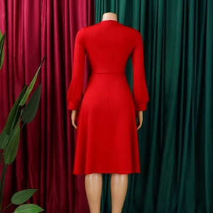 Back view of a red long-sleeve maxi dress showing waistline and invisible zipper closure