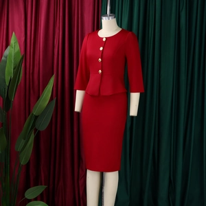 Close-up of red two-piece suit top with golden buttons and elegant ruffle hem detail