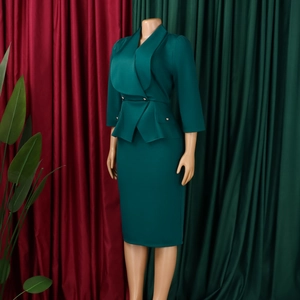 Detailed view of dark green pencil skirt with waist peplum and gold button accents