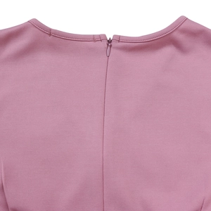 Detail shot of pink knitted dress featuring back invisible zipper and round neckline