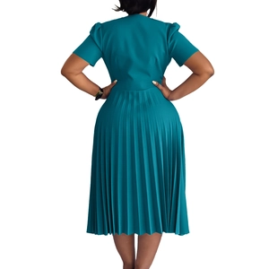 Rear view of this elegant teal pleated dress showing the fitted waist and midi hemline