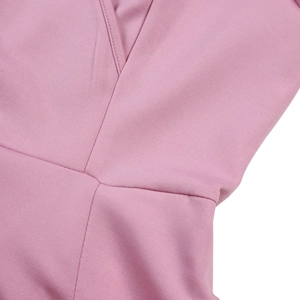Detail shot of the V-neck seam and high-quality pink fabric texture of the dress