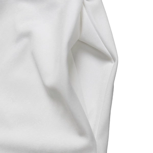 Detail shot of a white dress showing the deep side pocket and premium knit texture