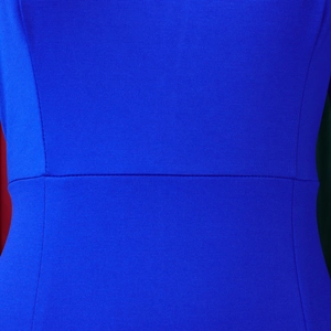 Macro shot of waist seam details and textured blue fabric on elegant long-sleeved dress