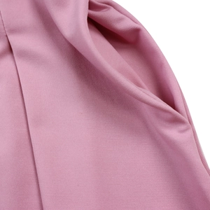 Detail view of pink dress fabric texture and side pocket design for a stylish look
