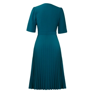 Detail view of dark green pleated dress showing back cut and elegant waist design