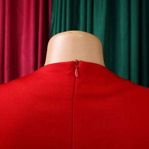 Close-up detail of a red elegant high-waisted dress with invisible zipper closure on back