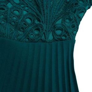 Detailed view of dark green dress showing intricate lace floral patterns and pleated fabric