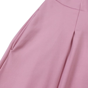 Detail of elegant pink dress showing invisible side pocket and pleated waist craftsmanship