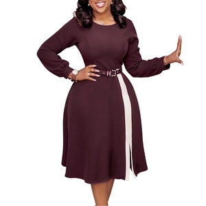 Detailed view of the split hem and vertical white contrast stripe on burgundy dress