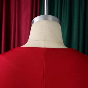 Detail shot of elegant red dress neckline with professional stitching and fine knit texture
