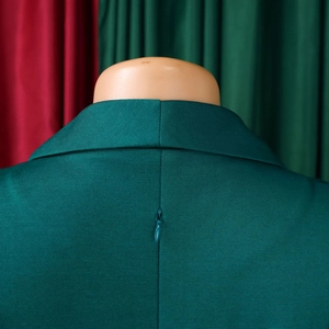 Detail of the deep green dress featuring a back invisible zipper and twill fabric texture