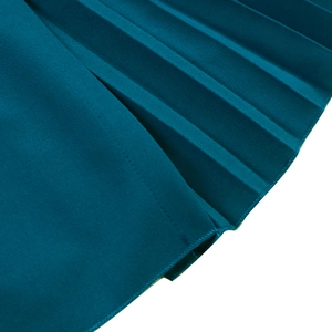 Detailed macro view of peacock blue pleated fabric with high-quality stitching and texture