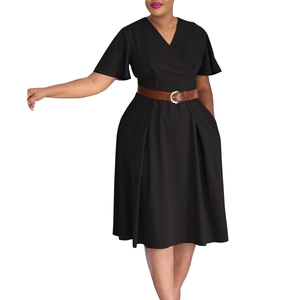 Detail of black V-neck dress featuring ruffled sleeves and a brown leather waist belt