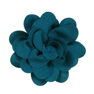 Detailed view of layered peacock green fabric flower petals with smooth finish