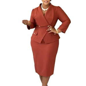 Detail view of brick red double-breasted blazer and pencil skirt set with gold buttons