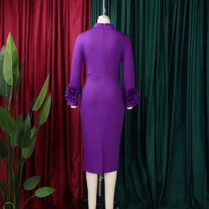 Close-up of purple fitted dress featuring a back slit and elegant ruffled cuffs detailing