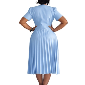 Rear view of light blue V-neck pleated dress showing fine accordion pleats and waist tie