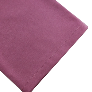 Dettaglio ravvicinato del tessuto a maglia malva con cuciture di alta qualità e trama