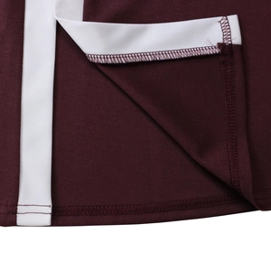 Detailed close-up of wine red dress hem with white side stripes and reinforced stitching