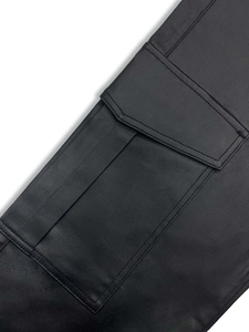 Detailed macro view of black cargo pants featuring durable twin-needle reinforced pockets