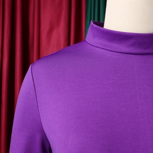 Detail of high collar purple knit dress with smooth shoulder tailoring and fine texture