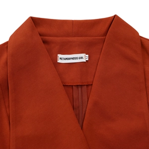 Detail of elegant rust red blazer neckline with brand label and fine sewing texture