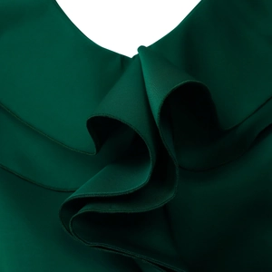 Detail of forest green dress featuring layered ruffle edges and high-density fabric texture