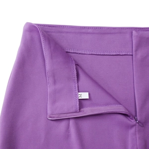 Detail of purple dress pants waist with invisible zipper, metal hook, and size M label