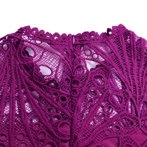 Close-up of deep purple lace dress neckline showing intricate hollow-out embroidery