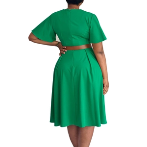 Detail view of emerald green dress back featuring flare sleeves and hidden zipper closure