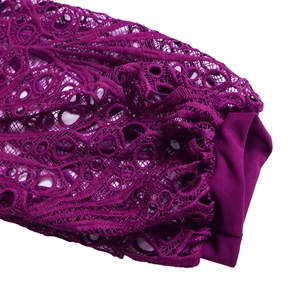 Detail shot of purple dress featuring intricate lace hollow patterns and smooth fabric cuffs