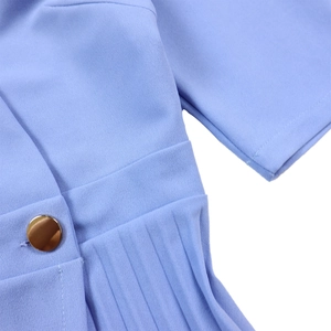 Detail of elegant lavender dress featuring pleated fabric and a textured gold button
