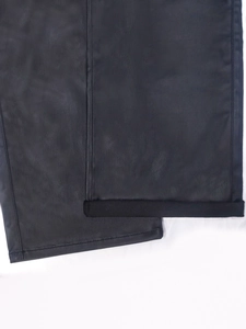 Women's black faux leather cargo pants featuring loose straight leg and cuffed hem detail