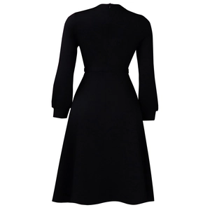 Detail view of the back of a black long-sleeve dress with a hidden zipper and A-line cut
