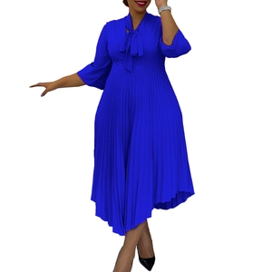 Detail of royal blue pleated midi dress featuring a pussy-bow neck and three-quarter sleeves