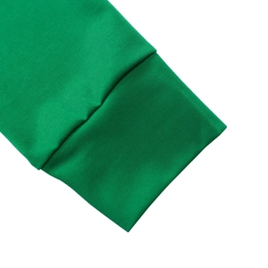 Detailaufnahme der grünen Rippstrickbündchen und des Saums am eleganten Kleid