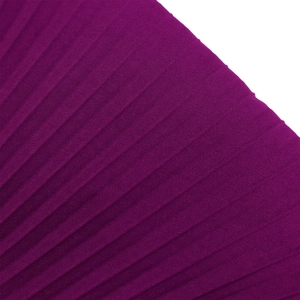 Detail of dark purple accordion pleated fabric showing rich texture and glossy finish