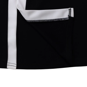 Macro detail of high-quality overlock stitching on the black and white contrast dress hem