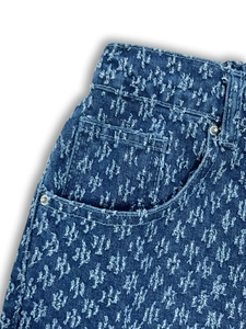 Blue denim pants featuring starry texture and distressed frayed details in loose straight fit
