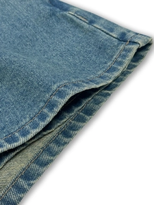 Close-up of blue denim fabric showing twill texture and double-row stitching details