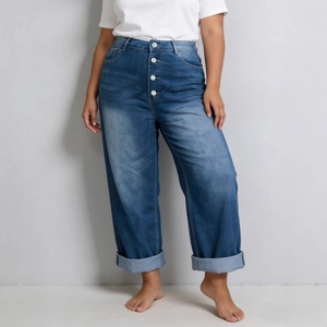 Detail of high waisted wide leg jeans showing multi-button fly and washed cat whiskers