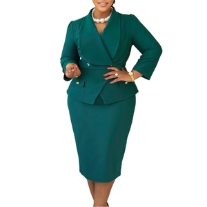 Detail of dark green blazer suit with wide shawl collar and double-breasted buttons